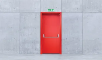 How should an emergency exit door be?